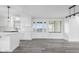 Bright kitchen features white cabinets, gray wood floors, and a view of the yard through the french doors at 4605 S 150 W, Columbus, IN 47201
