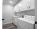 Laundry room with white cabinetry and washer/dryer units at 4605 S 150 W, Columbus, IN 47201