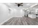 Open-concept living area with modern ceiling fan and wood-look floors at 4605 S 150 W, Columbus, IN 47201