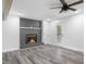 Living room featuring brick fireplace, ceiling fan and backyard access at 4605 S 150 W, Columbus, IN 47201