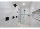 This shower includes black hardware, decorative tile, and a built-in toiletry shelf at 4605 S 150 W, Columbus, IN 47201