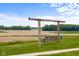 Inviting swing set offers a relaxing outdoor space with picturesque farmland views and lush green surroundings at 4605 S 150 W, Columbus, IN 47201