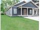 Charming blue house featuring a covered front porch and well-manicured lawn at 4625 W Naomi St, Indianapolis, IN 46241