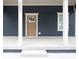 Close-up view of the front porch featuring white pillars and a modern front door at 4625 W Naomi St, Indianapolis, IN 46241