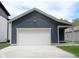 A modern two car garage with white garage door at 4625 W Naomi St, Indianapolis, IN 46241