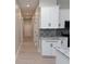 Open kitchen with a view of a well-lit hallway, white doors and modern finishes at 4625 W Naomi St, Indianapolis, IN 46241