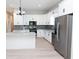 Stylish kitchen with a center island, stainless steel appliances, and sleek white cabinets at 4625 W Naomi St, Indianapolis, IN 46241