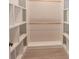 Spacious walk-in closet with custom shelving and wood rods offers a great organization system at 4625 W Naomi St, Indianapolis, IN 46241