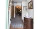 Inviting foyer with a decorative cabinet, soft carpet, and an arched entryway into the living area at 540 Cahill Ln, Indianapolis, IN 46214