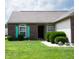 A well-kept single-story home with brick and siding, featuring vibrant turquoise shutters at 540 Cahill Ln, Indianapolis, IN 46214
