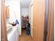 Hallway featuring pantry shelving, washing machine, dryer, storage, and linoleum flooring at 540 Cahill Ln, Indianapolis, IN 46214