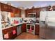 Efficient kitchen layout with stainless steel appliances, cherry cabinets, and a corner sink at 540 Cahill Ln, Indianapolis, IN 46214