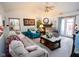 Comfortable living room with vaulted ceiling, plush sofas, fireplace and natural light through patio doors at 540 Cahill Ln, Indianapolis, IN 46214