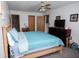 Bright main bedroom with a large bed, ceiling fan, and multiple closet options for ample storage at 540 Cahill Ln, Indianapolis, IN 46214