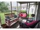 Relaxing screened porch featuring comfortable seating with decorative pillows and green spaces at 540 Cahill Ln, Indianapolis, IN 46214