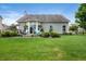 Expansive backyard includes a patio with seating, manicured lawn, and fenced perimeter at 5576 W Glenview Dr, McCordsville, IN 46055