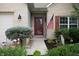 Inviting front entry with brick facade, American flag, and a beautiful garden, creating a warm, welcoming appeal at 5576 W Glenview Dr, McCordsville, IN 46055