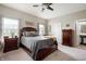 Comfortable main bedroom featuring a ceiling fan, ensuite bathroom access, and wood furniture at 5576 W Glenview Dr, McCordsville, IN 46055