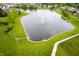 Scenic pond with a fountain surrounded by lush green landscaping and a walking path at 5576 W Glenview Dr, McCordsville, IN 46055