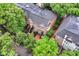 Aerial view showcasing townhouses with black roofs surrounded by mature trees and greenery at 558 E Vermont St, Indianapolis, IN 46202