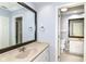Neutral bathroom with a vanity and large dark wood framed mirror at 558 E Vermont St, Indianapolis, IN 46202