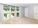 This is a bedroom with a carpeted floor, bay windows, and access to two doorways at 558 E Vermont St, Indianapolis, IN 46202