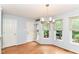 Charming dining area with hardwood floors and a stylish chandelier next to the sliding glass door at 558 E Vermont St, Indianapolis, IN 46202