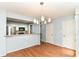 Open dining room next to modern kitchen with hardwood floors and stylish lighting at 558 E Vermont St, Indianapolis, IN 46202
