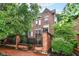 Charming brick home featuring a gated front entrance and landscaped yard, creating a welcoming curb appeal at 558 E Vermont St, Indianapolis, IN 46202