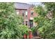 Elegant brick townhouse with landscaped front yard and gated entrance, perfect for privacy and curb appeal at 558 E Vermont St, Indianapolis, IN 46202
