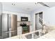 Modern kitchen featuring granite countertops, stainless steel appliances, and white cabinets at 558 E Vermont St, Indianapolis, IN 46202