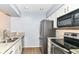 Modern kitchen with stainless steel appliances, granite countertops, and white cabinetry, offering style and functionality at 558 E Vermont St, Indianapolis, IN 46202
