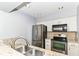 Modern kitchen with stainless steel appliances, granite countertops, and white cabinetry, with a modern faucet at 558 E Vermont St, Indianapolis, IN 46202