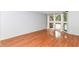 Spacious living room featuring hardwood floors, neutral paint, and bright windows at 558 E Vermont St, Indianapolis, IN 46202