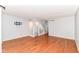 Neutral living room with hardwood floors, wall-mounted TV, and staircase at 558 E Vermont St, Indianapolis, IN 46202