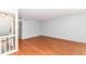 Open living room with hardwood floors, neutral paint, and staircase access at 558 E Vermont St, Indianapolis, IN 46202