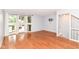 Bright living room with hardwood floors, large windows, and a staircase leading upstairs at 558 E Vermont St, Indianapolis, IN 46202