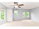 Spacious main bedroom with plush carpet, fan and large windows with blinds at 558 E Vermont St, Indianapolis, IN 46202