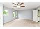 Comfortable bedroom with carpet, ceiling fan, and windows with view of trees at 558 E Vermont St, Indianapolis, IN 46202