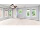 Large bedroom with carpet, ceiling fan, neutral paint, and three windows with green views at 558 E Vermont St, Indianapolis, IN 46202