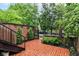 Serene brick patio surrounded by lush greenery, perfect for outdoor relaxation and entertaining at 558 E Vermont St, Indianapolis, IN 46202