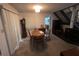 Carpeted dining room with an oval wood table set, next to the staircase at 5711 Bradston Way, Indianapolis, IN 46237