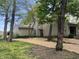 Charming home exterior featuring mature trees, a garage and a driveway with wood chips at 5711 Bradston Way, Indianapolis, IN 46237