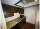Kitchen featuring dark cabinets, wood countertops, and stainless steel sink at 5711 Bradston Way, Indianapolis, IN 46237