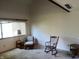 Cozy living room featuring a rocking chair, neutral carpet, and bright natural light at 5711 Bradston Way, Indianapolis, IN 46237