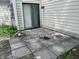 Backyard patio with stone pavers, wood siding, and an open sliding glass door at 5711 Bradston Way, Indianapolis, IN 46237