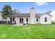 House with a big backyard and a patio with sliding glass doors at 6011 Twyckenham Dr, Indianapolis, IN 46236