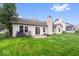 Home exterior featuring a patio, fenced backyard, and sliding glass door at 6011 Twyckenham Dr, Indianapolis, IN 46236