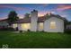 House with a big backyard and a patio with sliding glass doors at 6011 Twyckenham Dr, Indianapolis, IN 46236