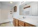 Bright bathroom featuring a tub and shower, vanity, and built-in storage at 6011 Twyckenham Dr, Indianapolis, IN 46236